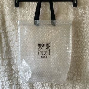 MOSCHINO Teddy couture Milano clear bubble shoe dust bag, with black handles.